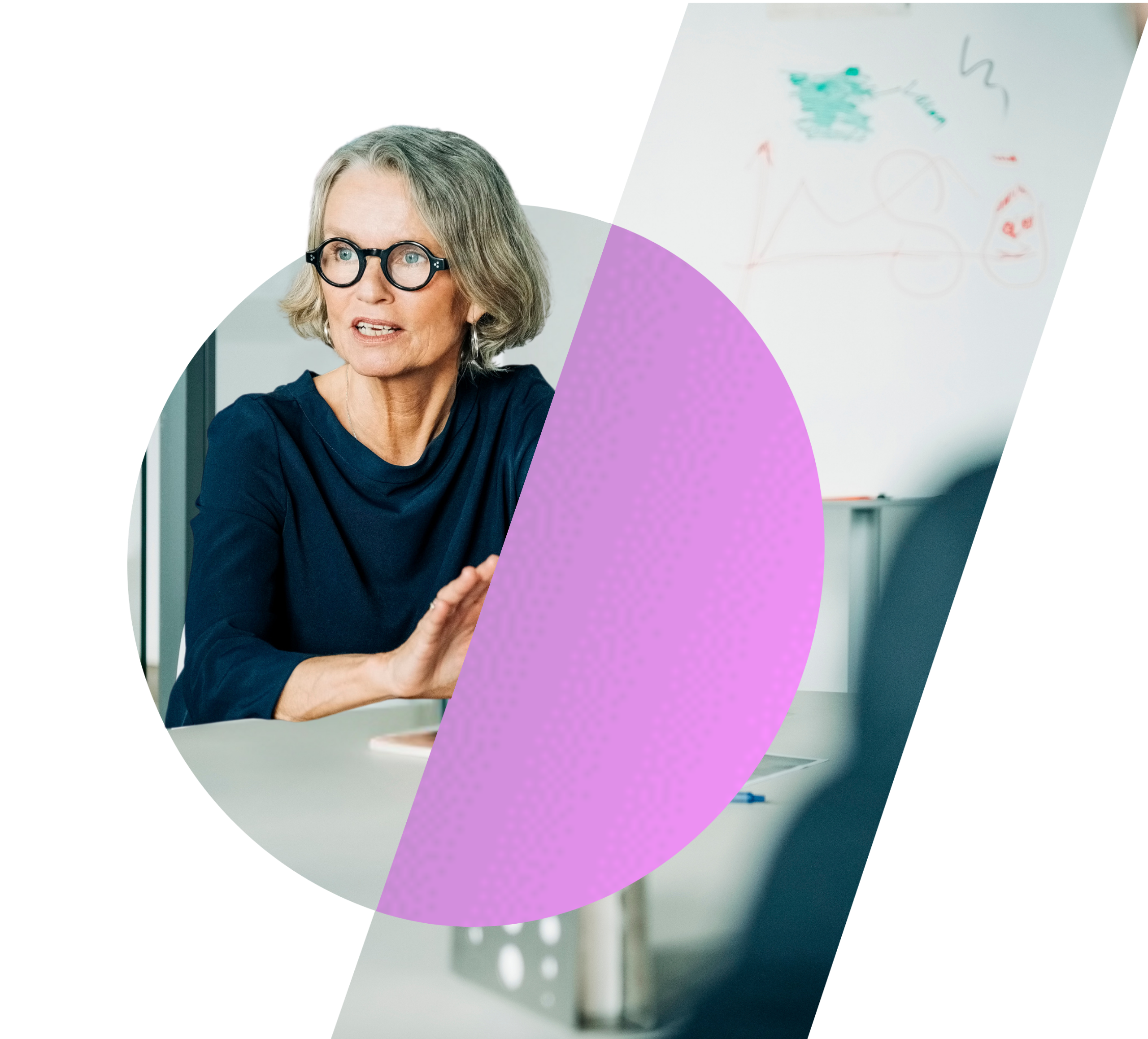 A mature businesswoman wearing glasses at a boardroom table