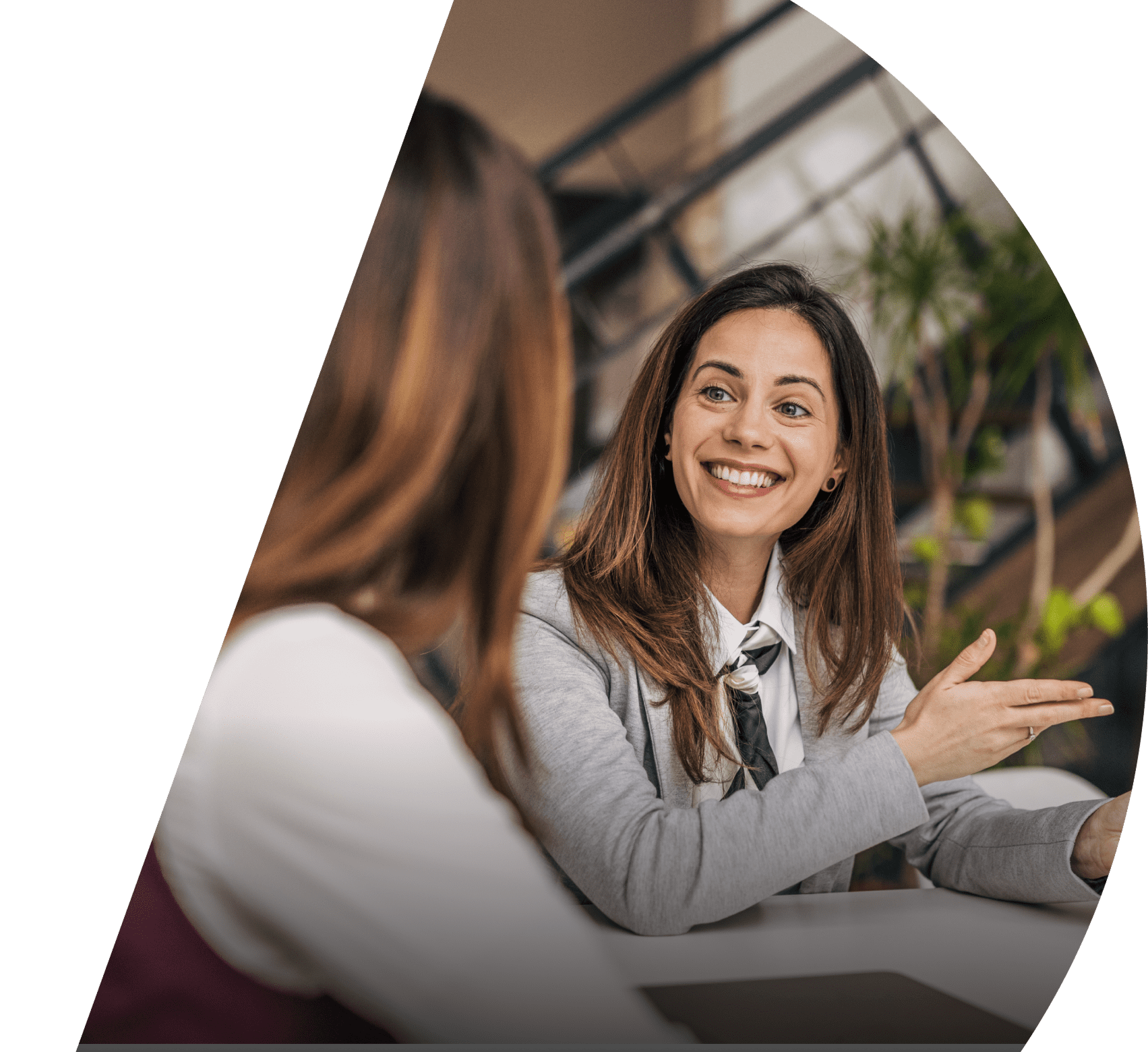A couple of businesswomen engage in conversation.