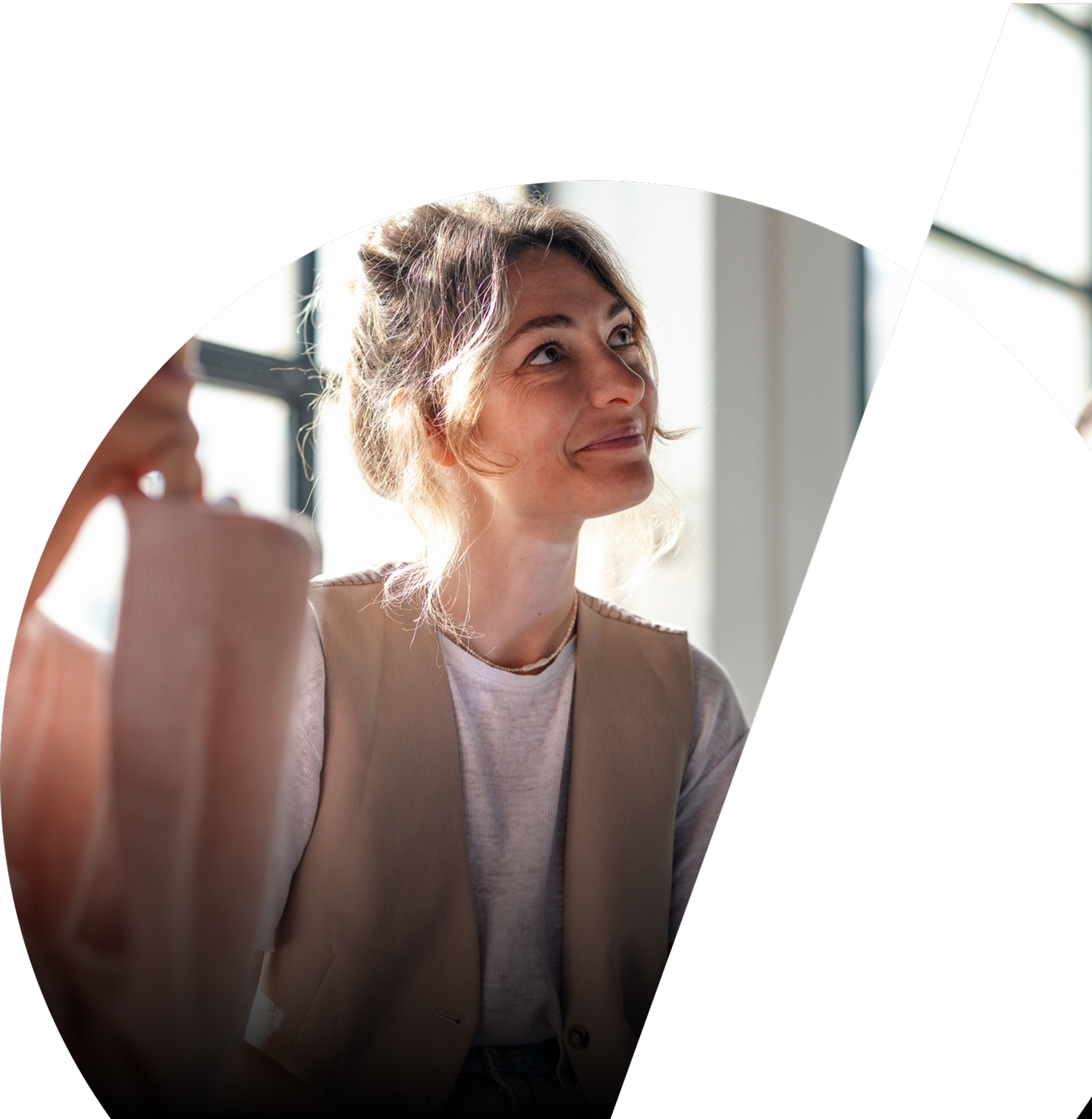 A woman smiles whilst looking up attentively